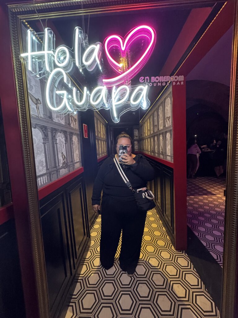 Latina woman taking mirror selfie in Monterrey Mexico at En Boilerroom Lounge Bar before bariatric surgery